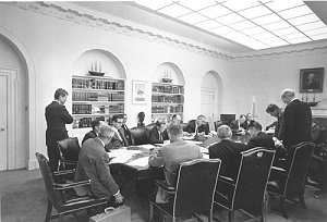 President Kennedy in a crowded Cabinet Room during the Cuban Missile Crisis.